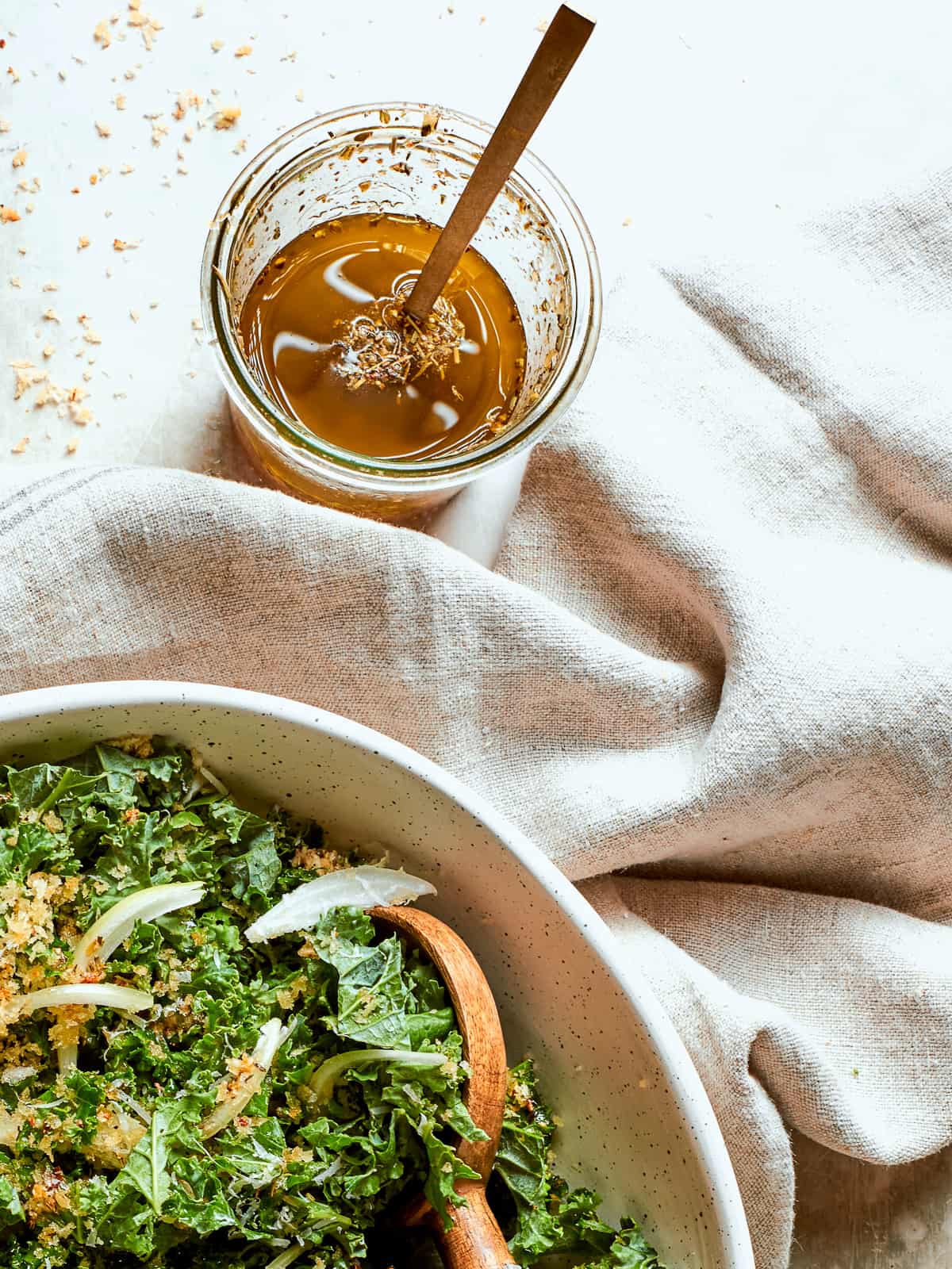 Jar of Italian salad dressing resting near a soft cloth napkin.