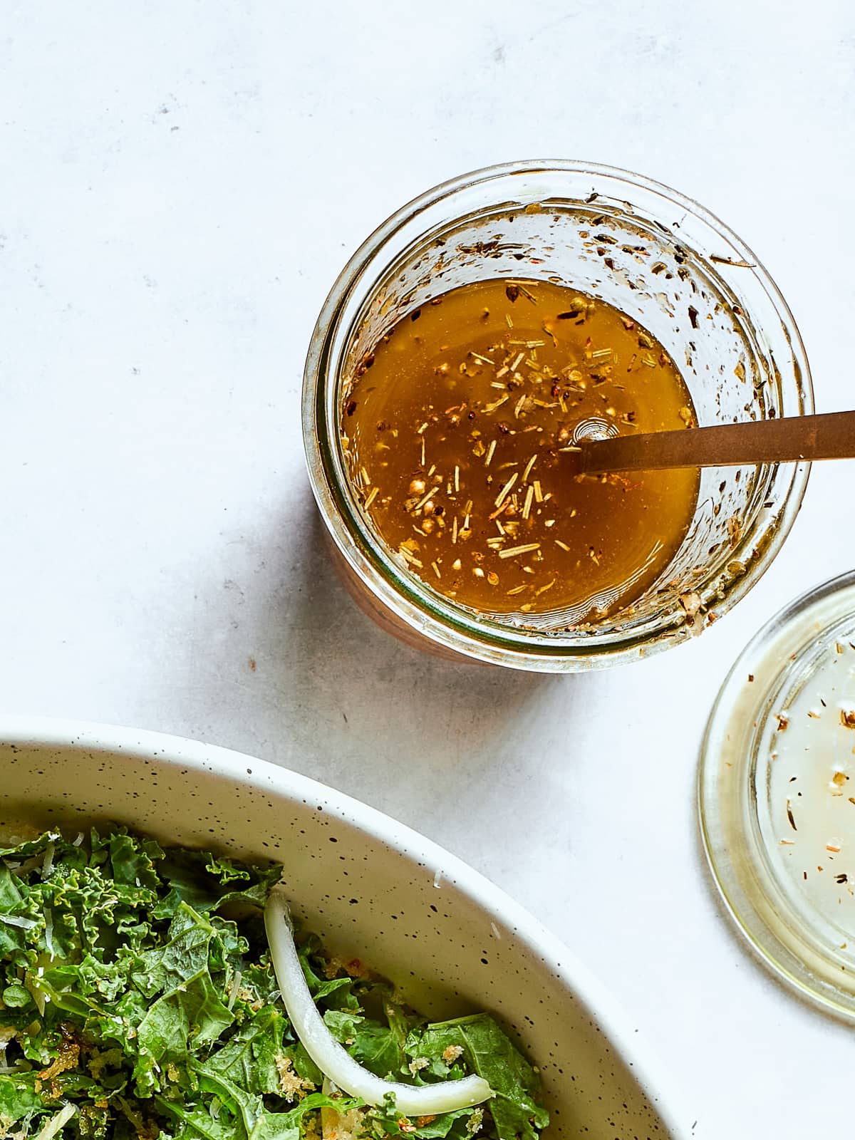 homemade Italian salad dressing with flecks of oregano and cheese.