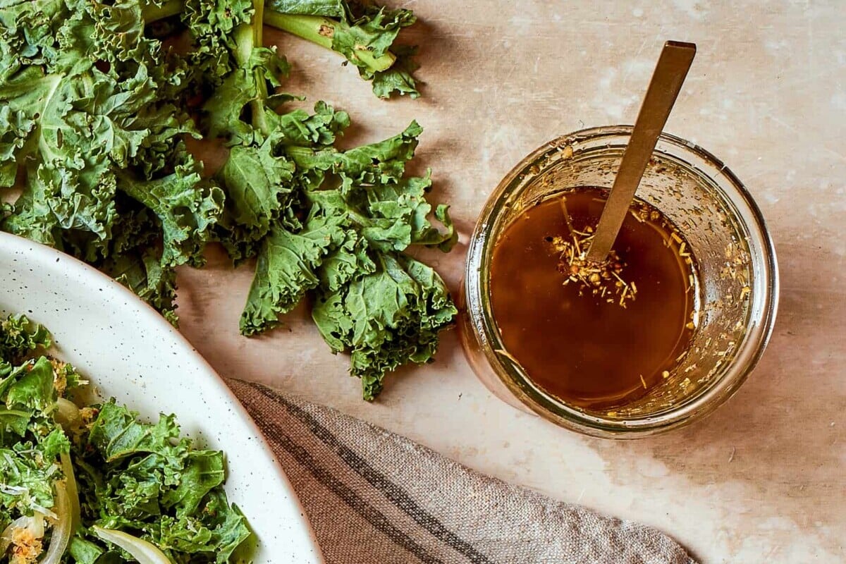 Homemade Italian salad dressing in a jar, ready to pour over crisp greens.