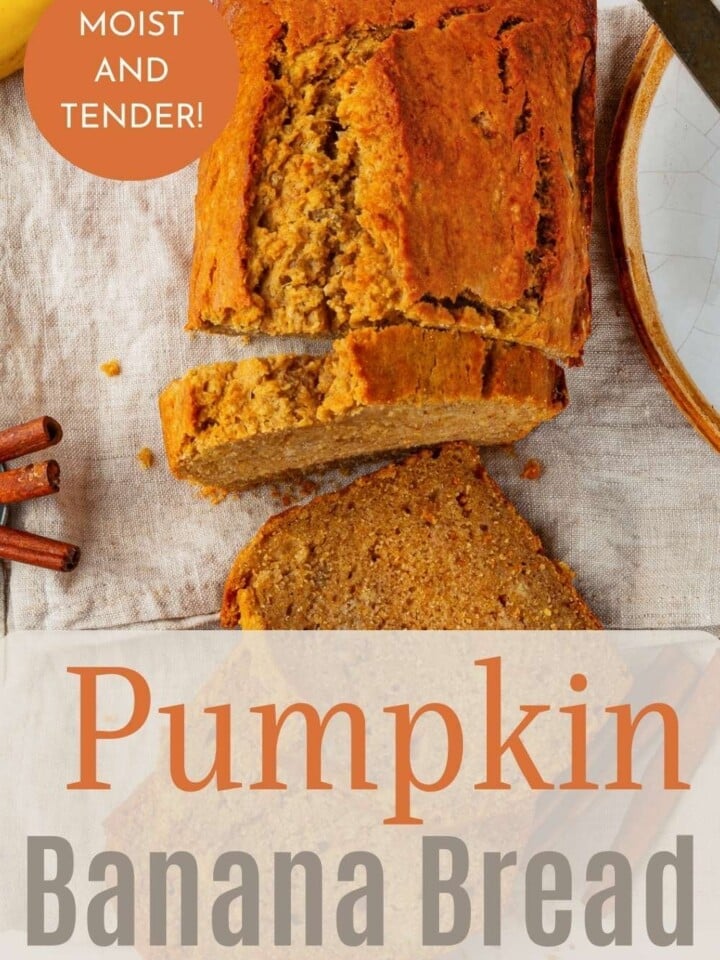Sliced pumpkin banana bread on a table, surrounded by bananas and warm spices.