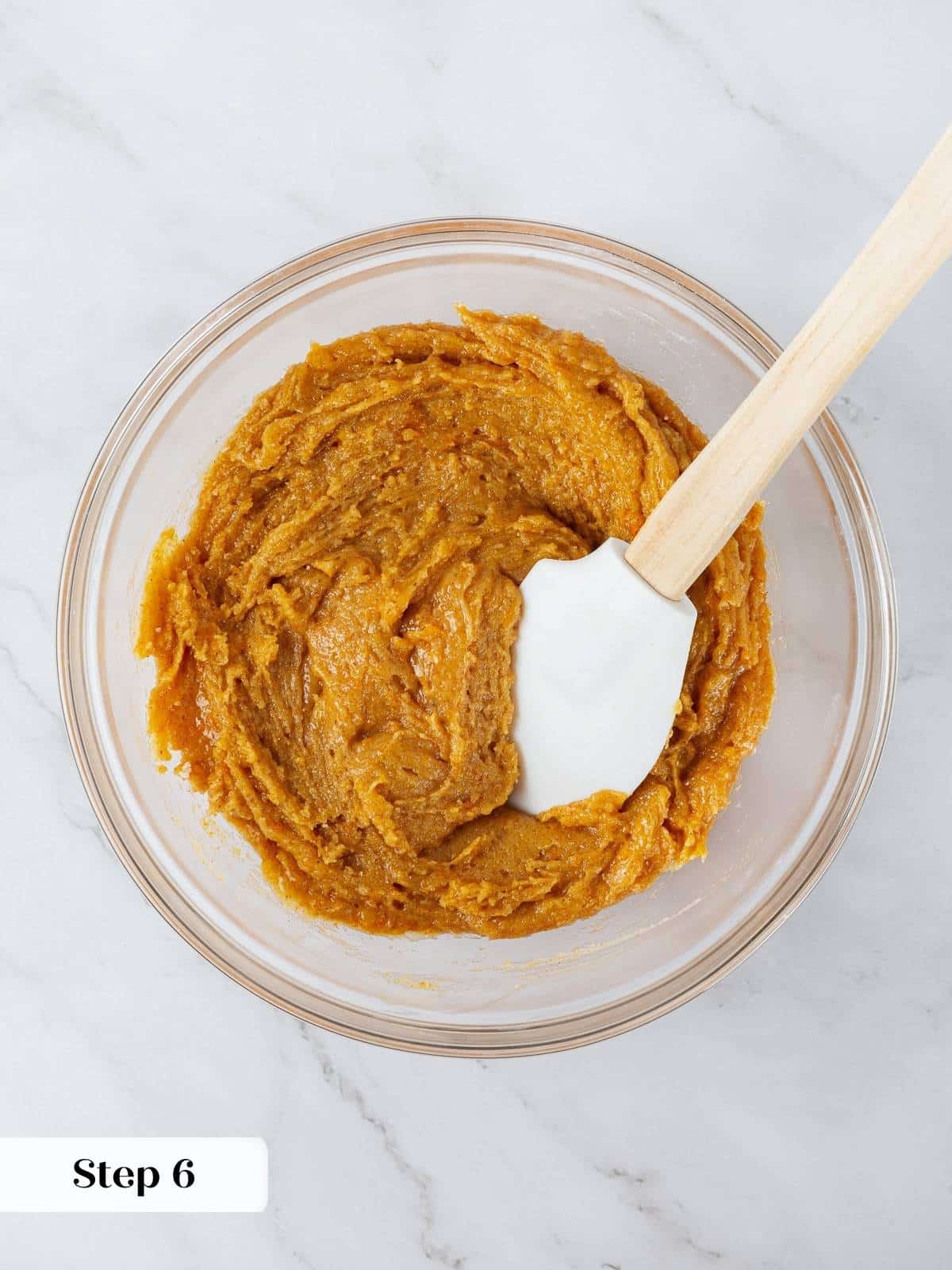 Pumpkin snickerdoodle cookie batter mixed in a bowl, ready for chilling and scooping.