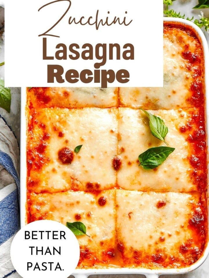 Sliced zucchini layered with herbed ricotta, chicken tomato sauce, and bubbly cheese in a white dish.