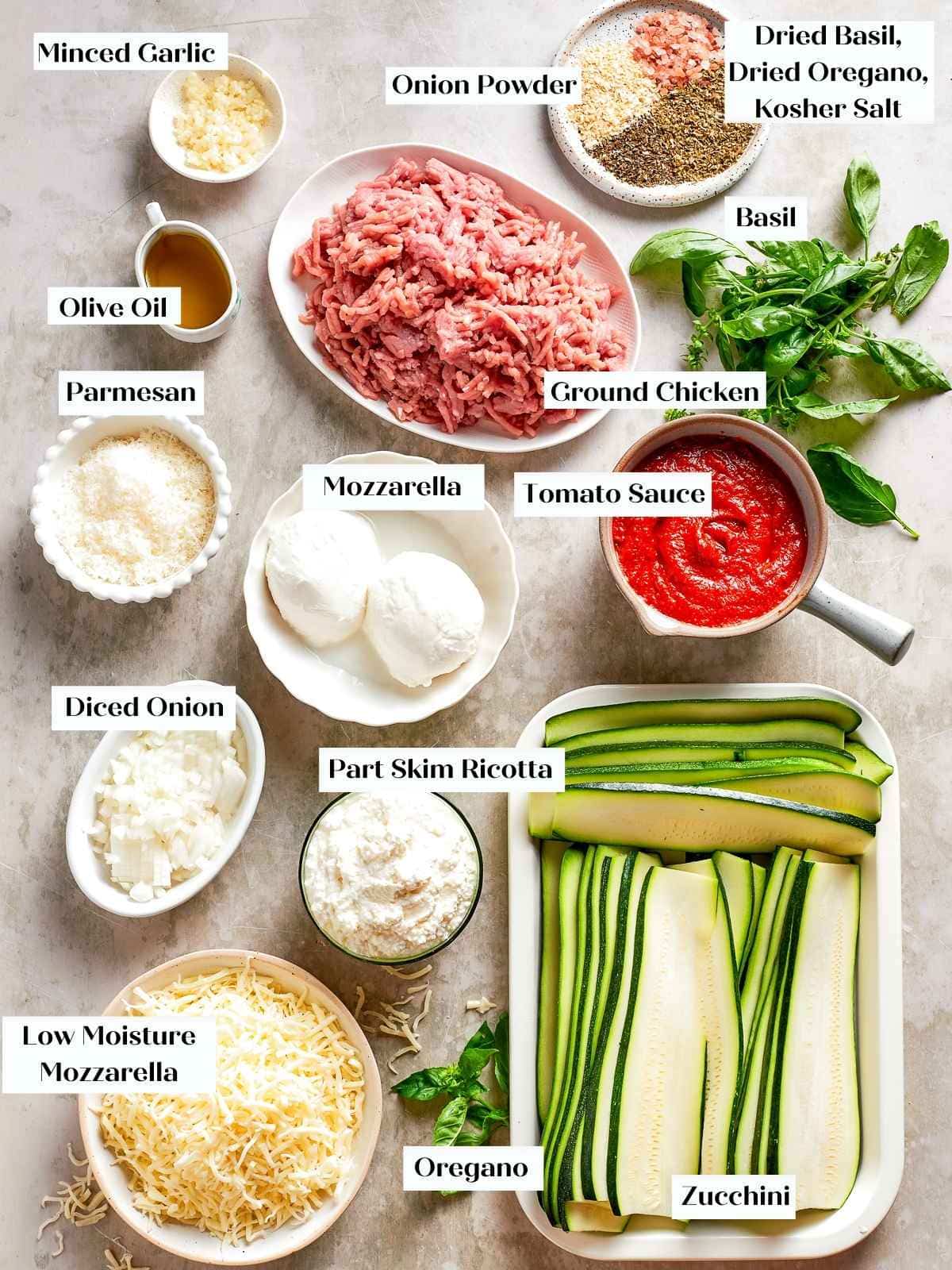 Ingredients for zucchini lasagna laid out before cooking, including zucchini, ricotta, garlic, and cheese.