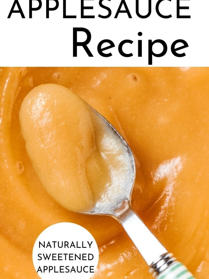 A spoon dipped into silky applesauce, highlighting rich color and natural homemade apple flavor.