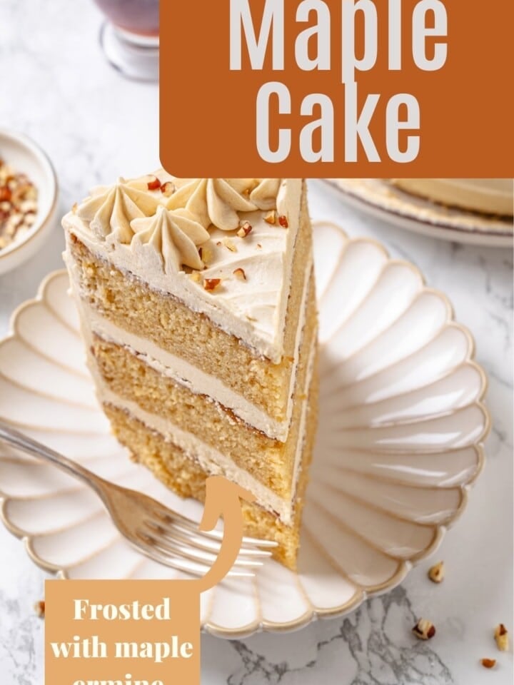 Slice of maple cake on a plate, showing fluffy layers and smooth maple frosting.