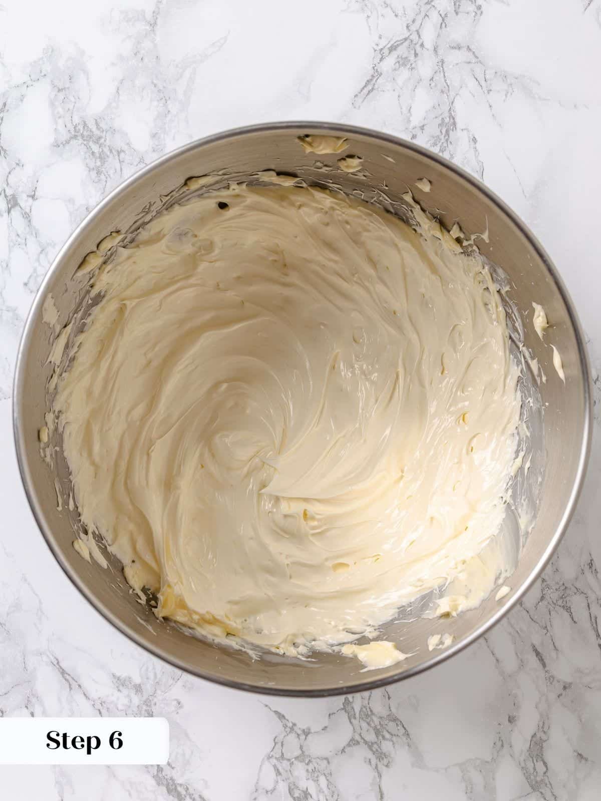 Butter beaten in stand mixer until fluffy, preparing to add cooled maple frosting base.