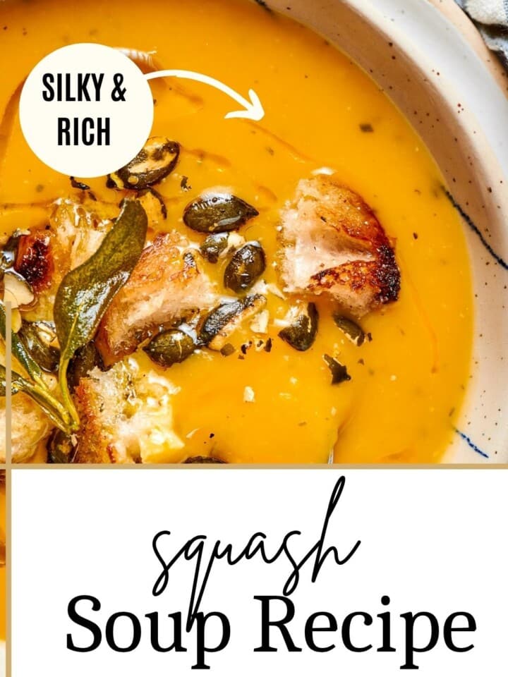 Bowl of creamy butternut squash soup garnished with pepitas and fresh herbs on the table.