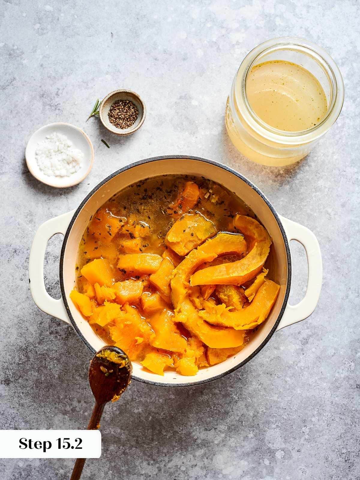 vegetable stock added into pot of cooked squash and aromatics for blending.