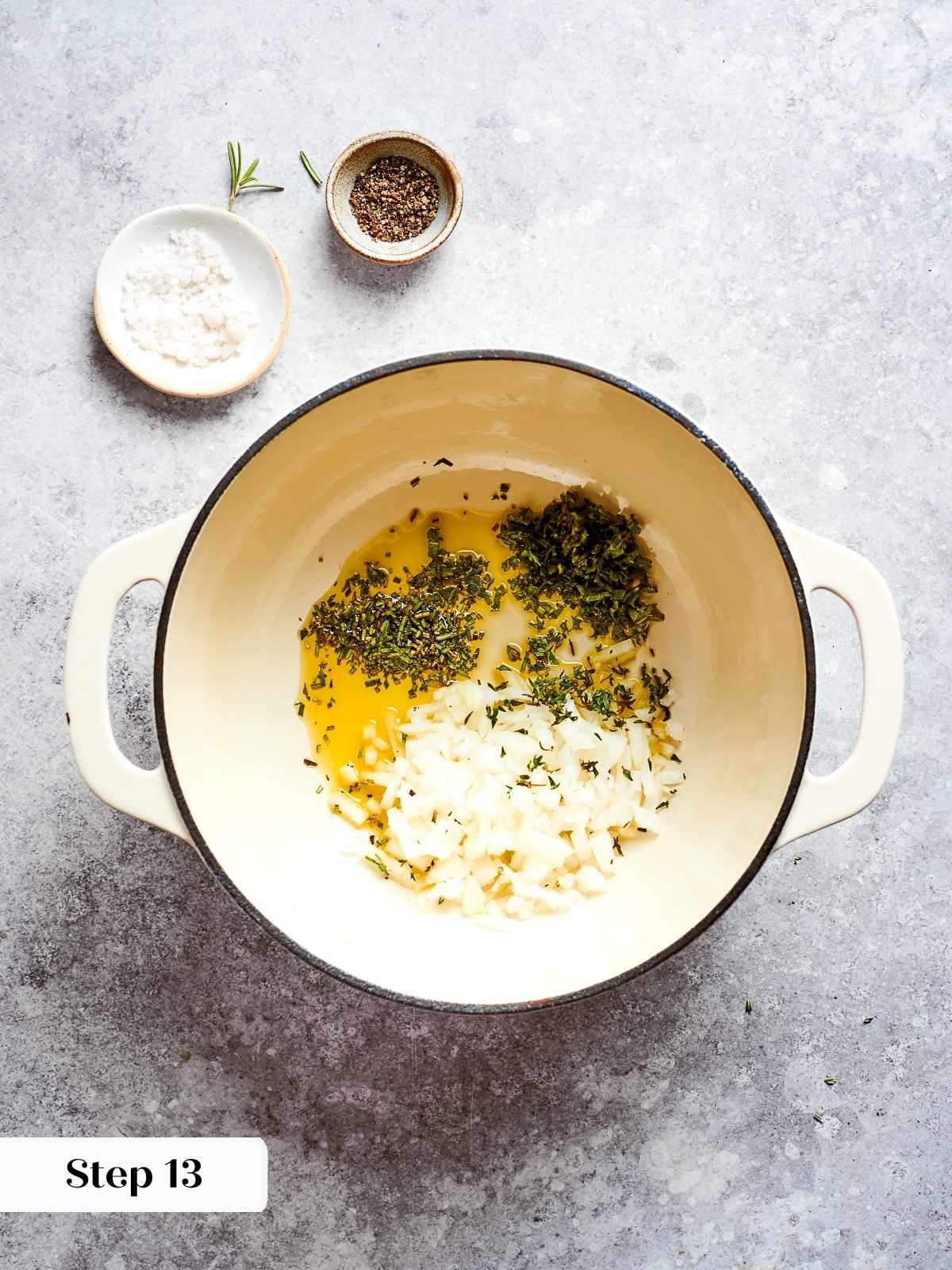 Onions and herbs sautéing gently in olive oil at the bottom of a soup pot.
