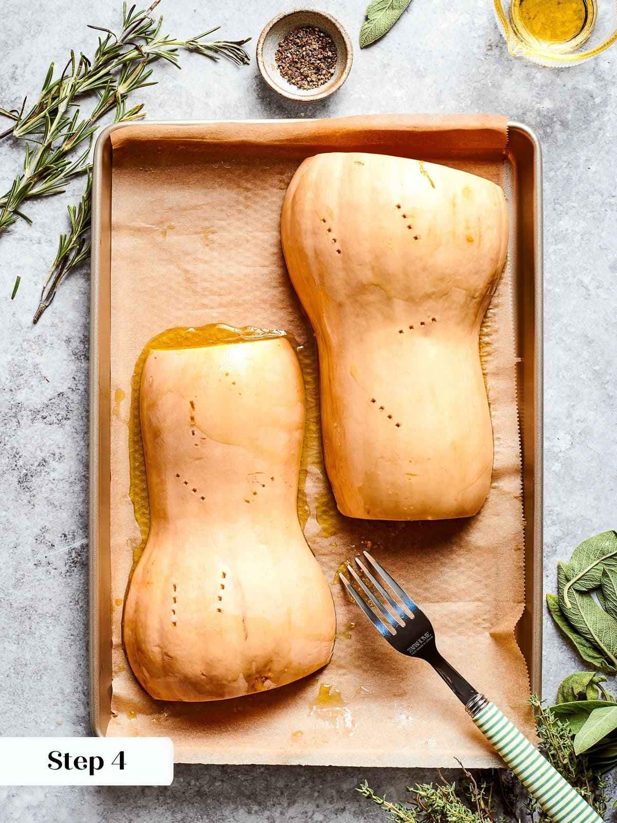 Squash halves placed face down on tray, ready to caramelize in oven.