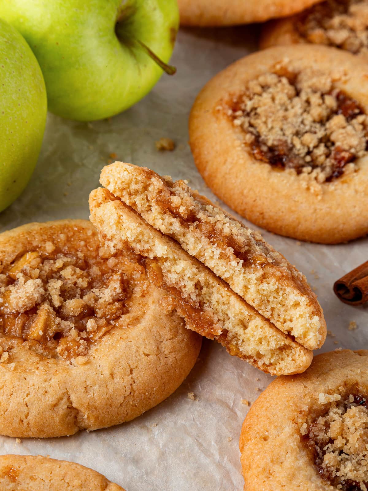 Cookie broken in half revealing gooey apple filling inside a chewy brown sugar dough.