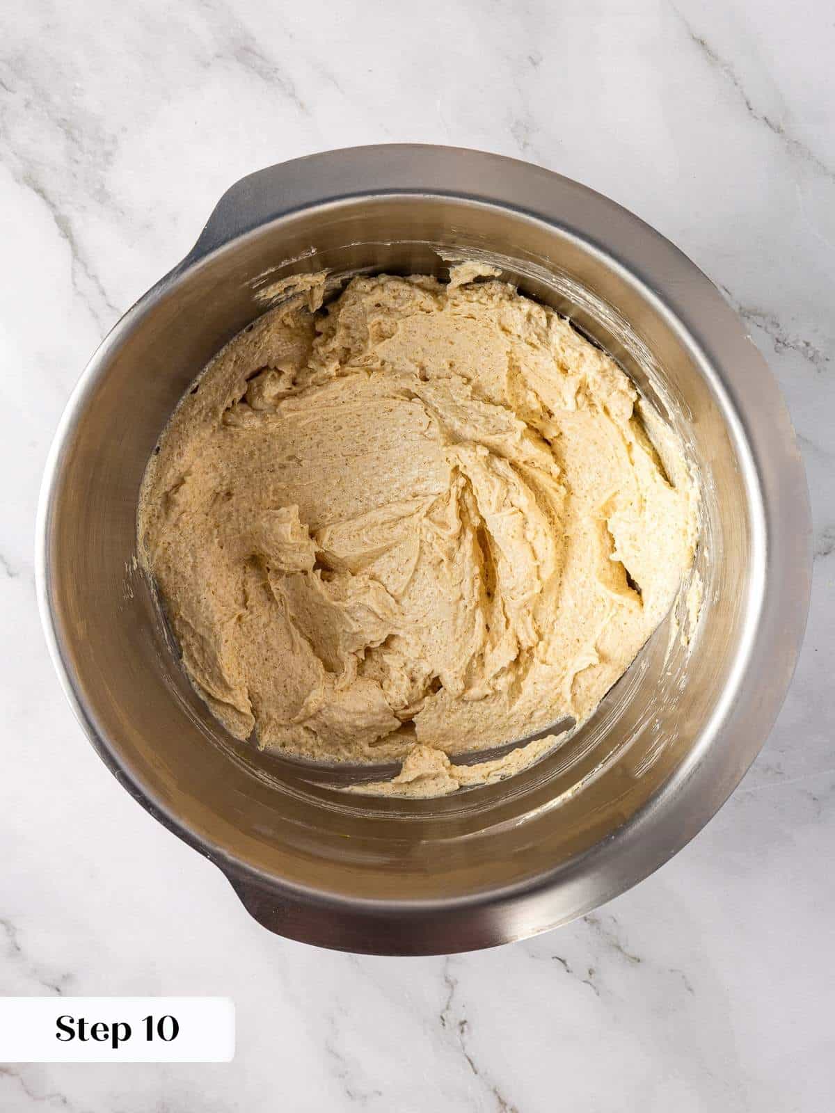 Mixing bowl with egg and vanilla being stirred into brown sugar butter cookie base.