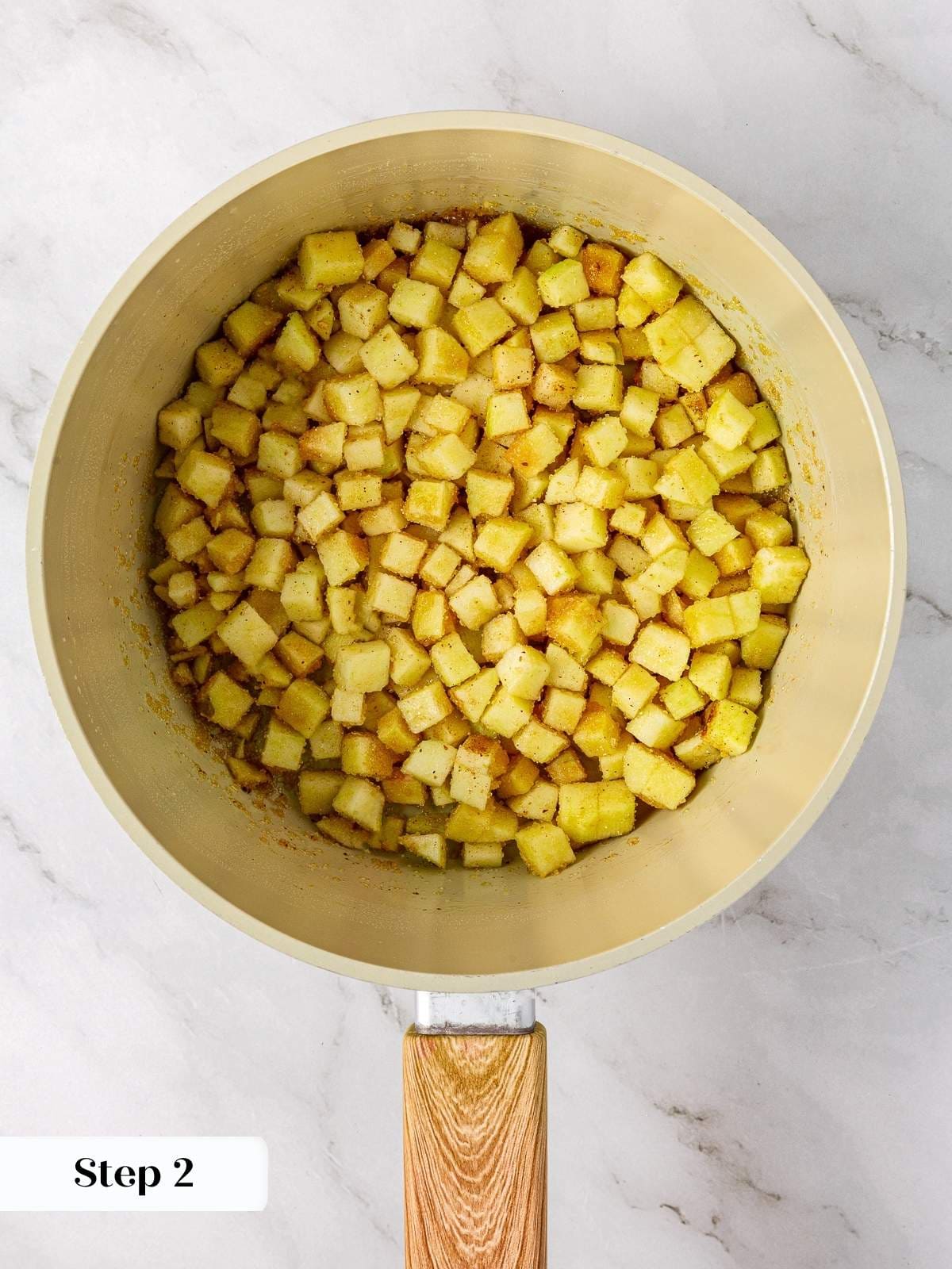 Chopped apples cooking down with sugar and lemon juice to create the pie filling.