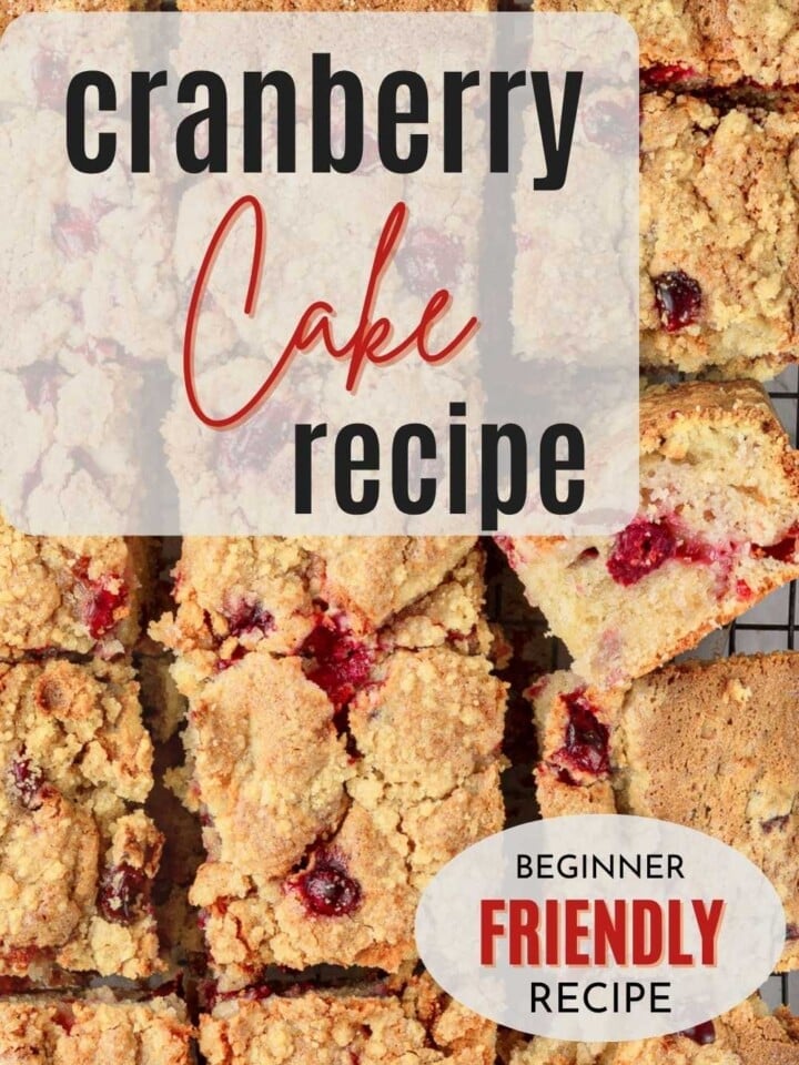 Whole cranberry cake sliced and sprinkled with sugar and filled with bright red berries baked into the batter.