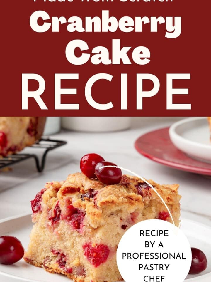 Golden cranberry cake with brown sugar streusel baked on top and sliced to show soft texture.