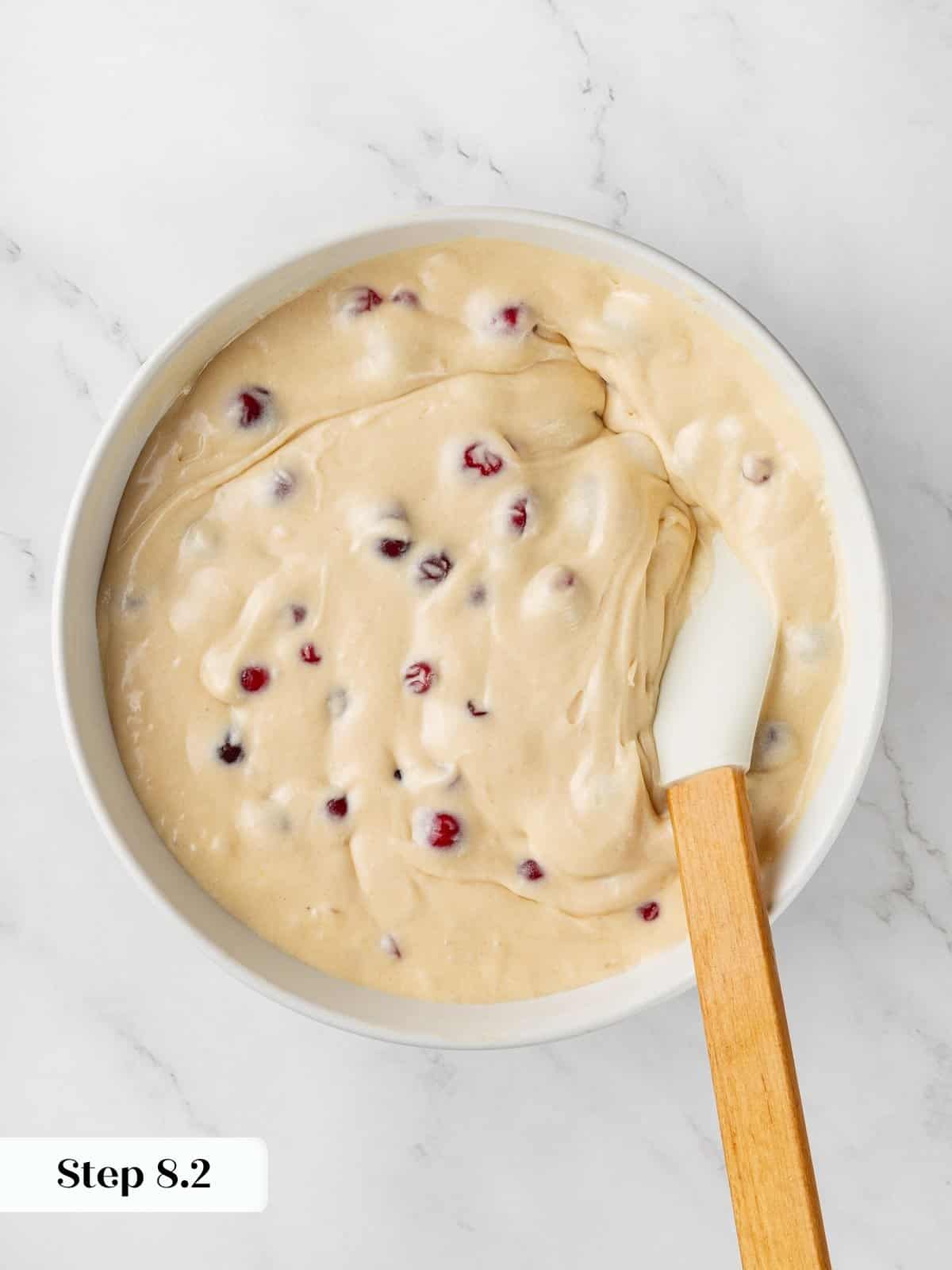 Thick cranberry cake batter resting in bowl showing creamy texture before baking.