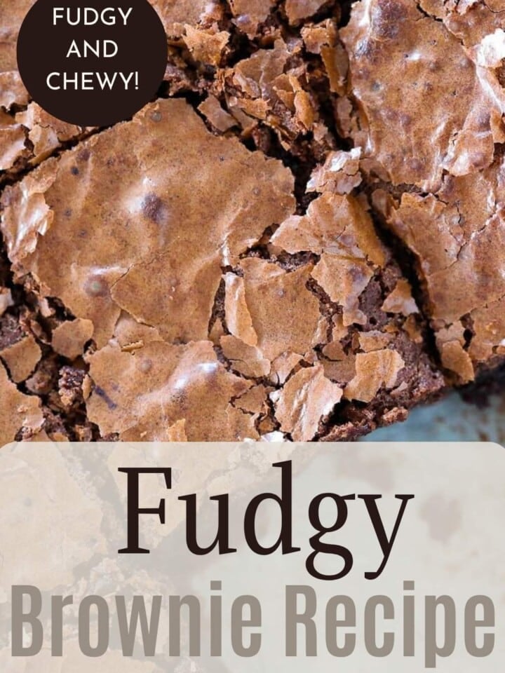 Rich chocolate brownie squares cooling on parchment paper after baking.