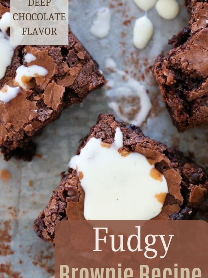 Freshly baked fudgy brownies sliced in a pan with golden crisp edges.