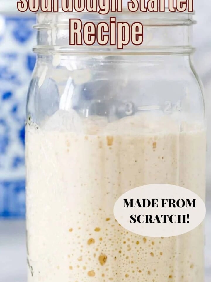 Thick, bubbly sourdough starter rising high in a glass jar.