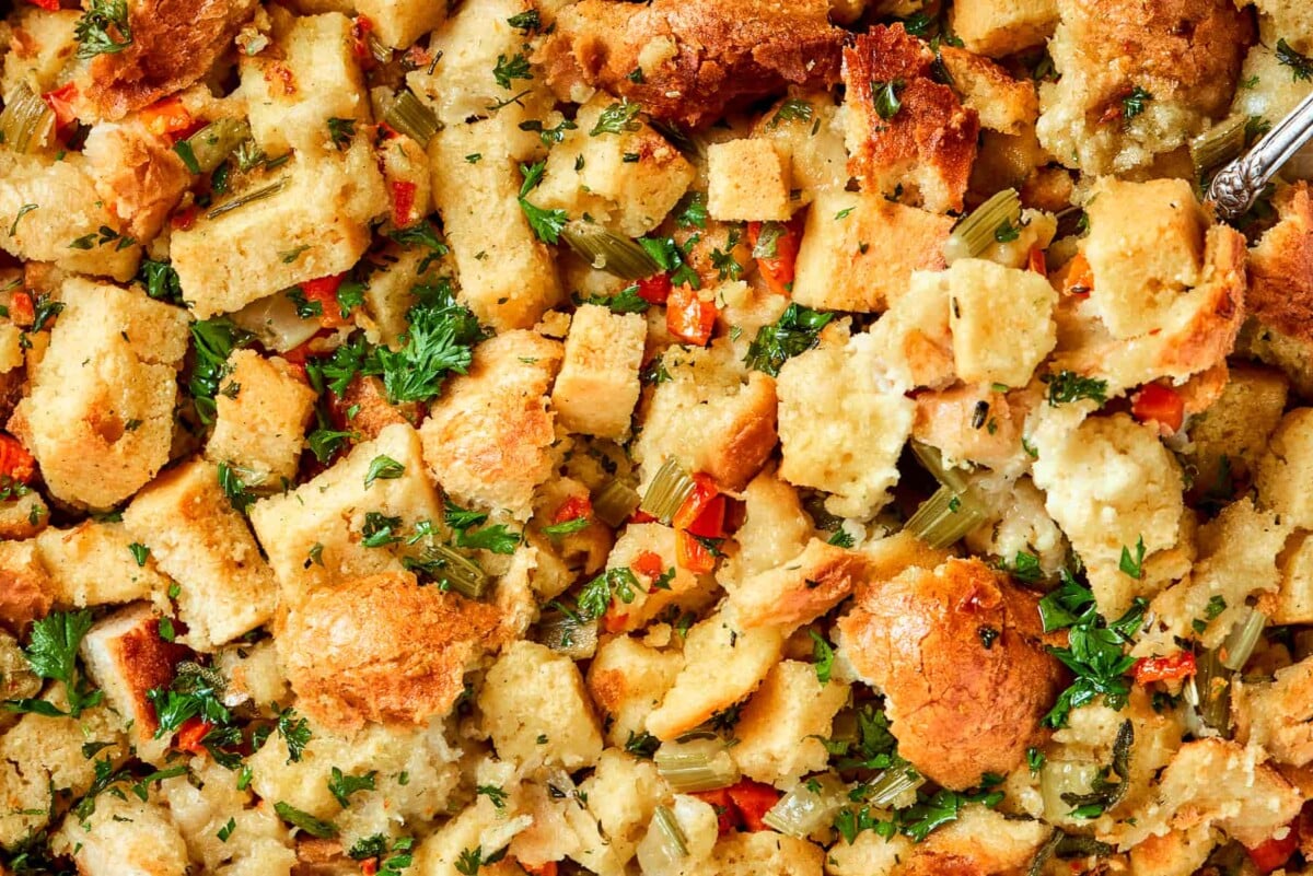 Cubes of cornbread and rustic bread showing in baked cornbread dressing.
