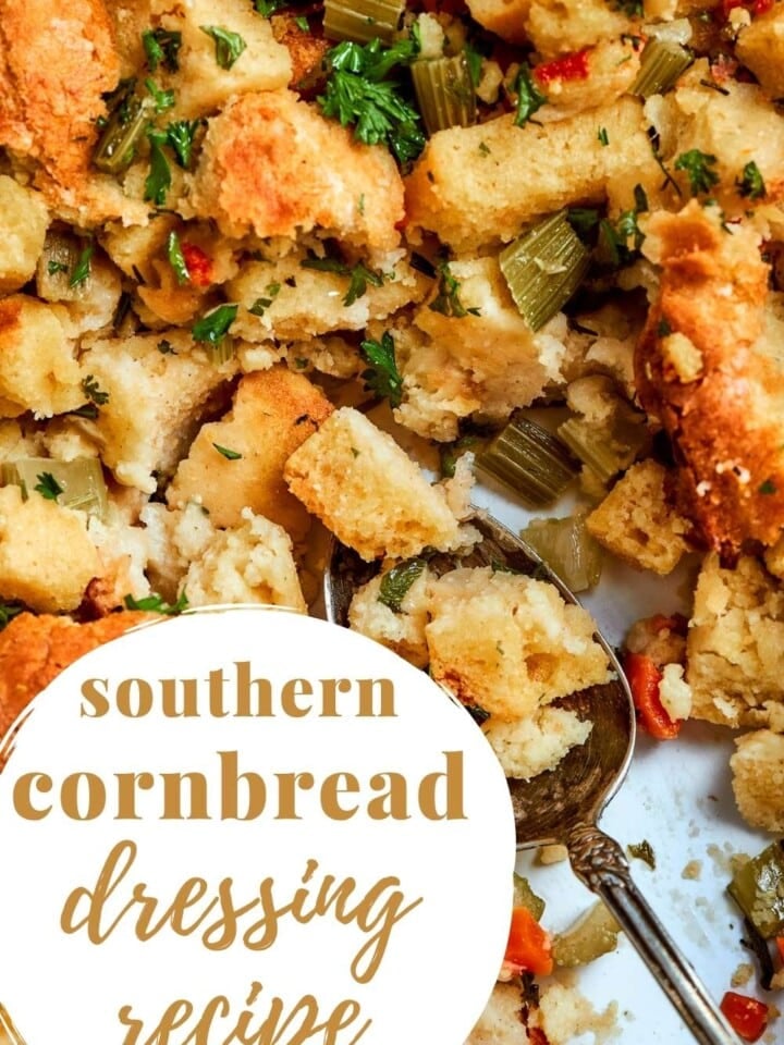 Spoonful of moist Southern cornbread dressing showing buttery texture and bits of celery and onion.