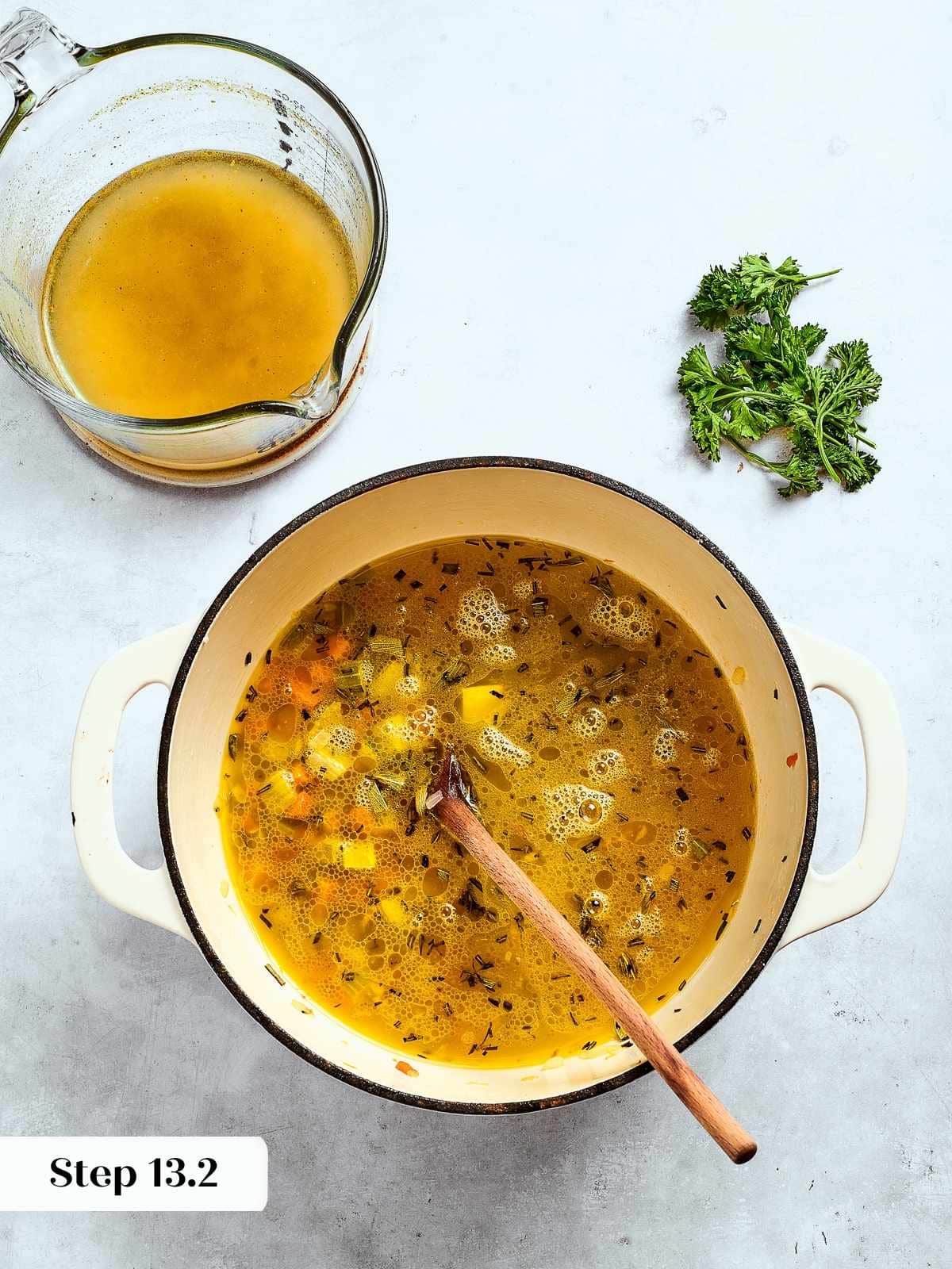 Chicken broth being poured into sautéed vegetables and herbs to build flavor for the dressing.