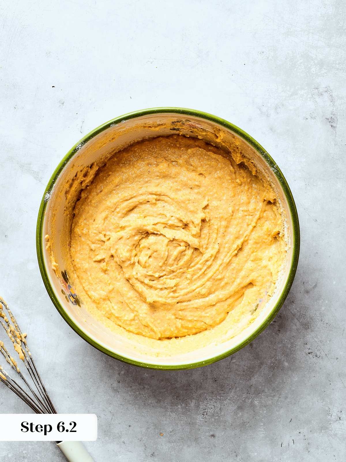 Finished cornbread batter in a mixing bowl showing smooth, creamy texture before baking.