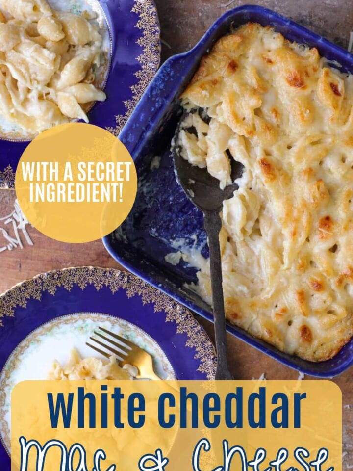 Smooth and creamy white cheddar macaroni and cheese in a baking dish with text noting use of a secret ingredient.