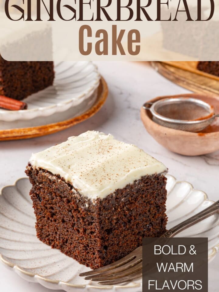 A square of gingerbread cake on a white plate.