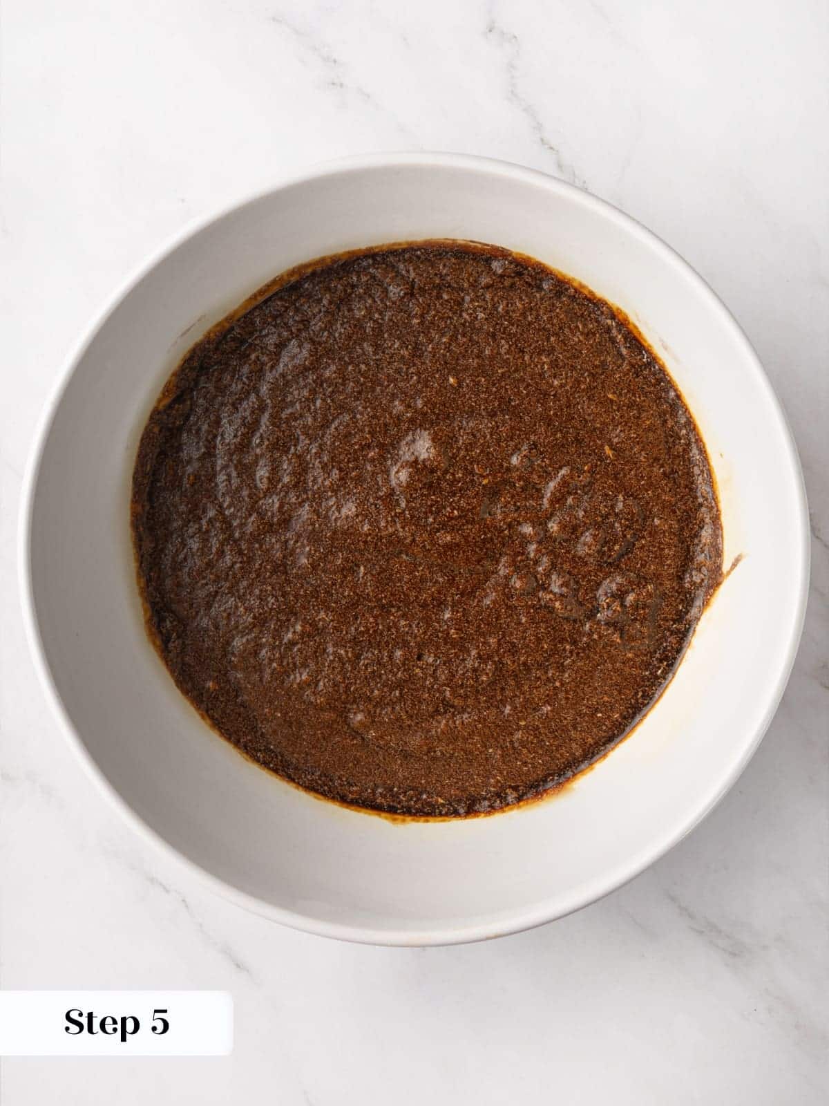 Butter and sugar beaten together in a bowl until creamy as the first mixing step.