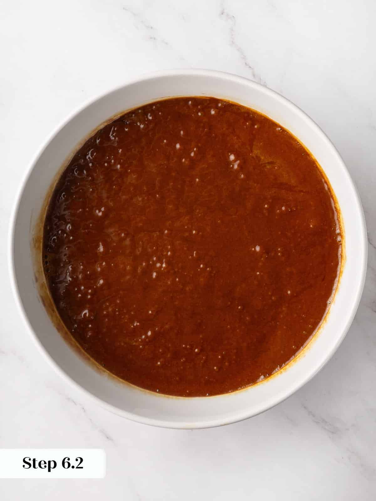 Smooth gingerbread cake batter in a mixing bowl, ready to pour into the pan.