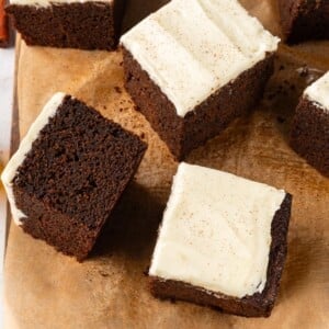 Multiple gingerbread cake slices arranged casually to highlight soft crumb and deep color.