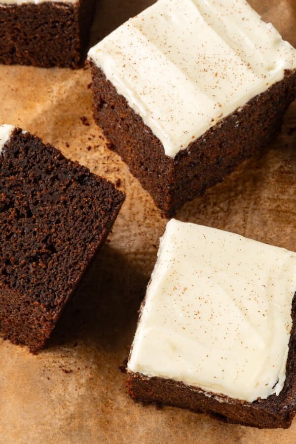 Multiple gingerbread cake slices arranged casually to highlight soft crumb and deep color.