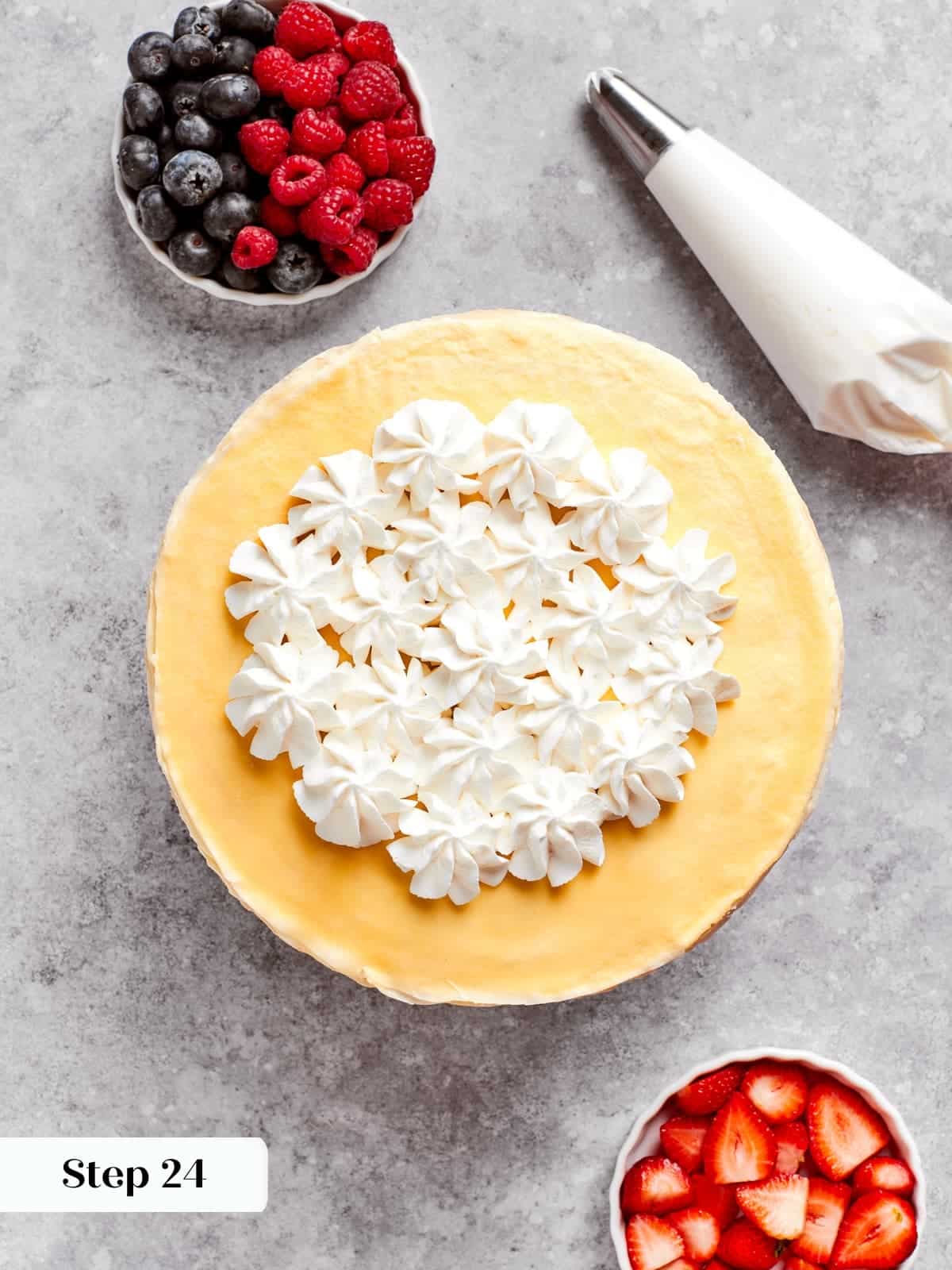 Finished crepe cake served with berries and soft whipped cream on top.