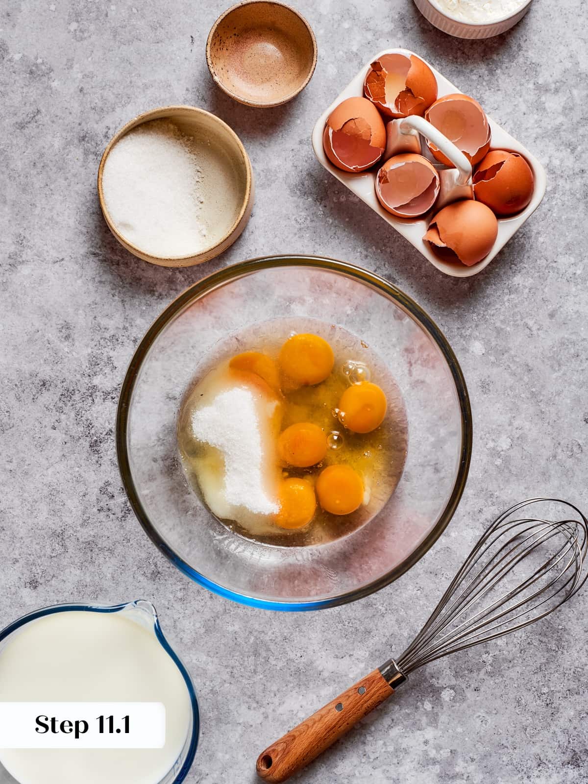 Ingredients for the pastry cream being whisked into a smooth mixture in a bowl.