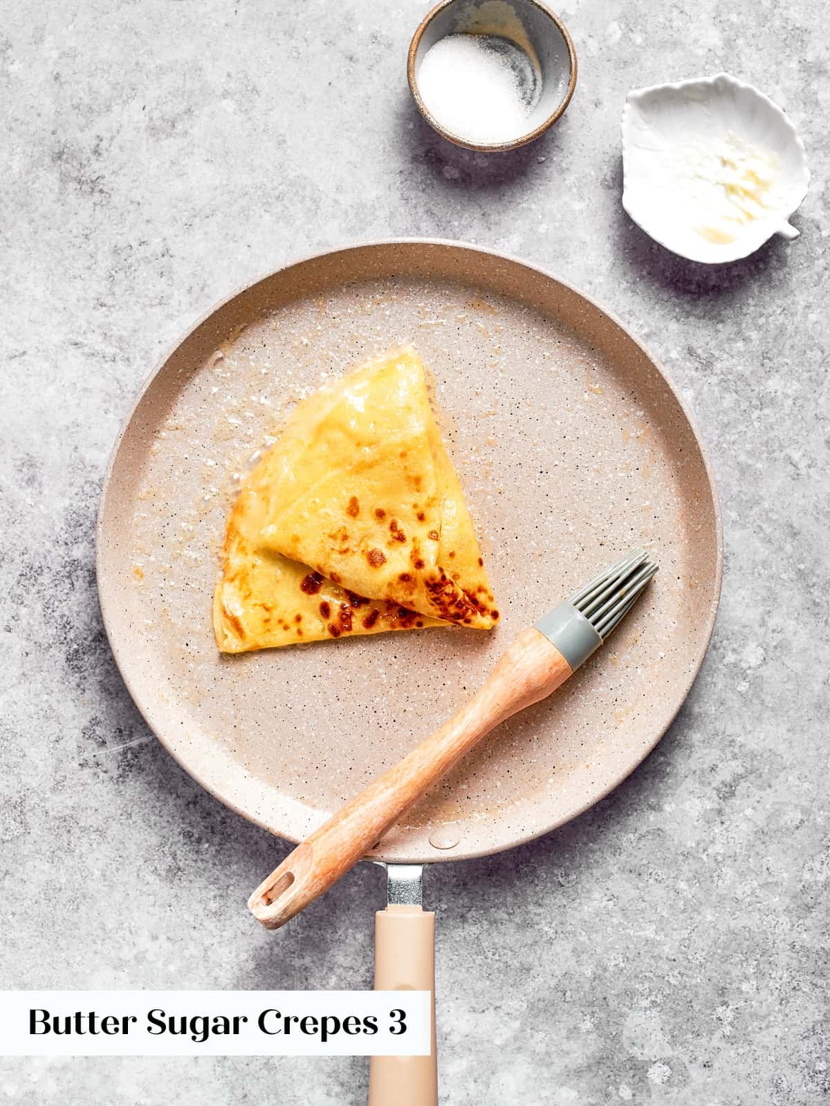Golden crepe folded again to create a classic triangle perfect for butter and sugar.