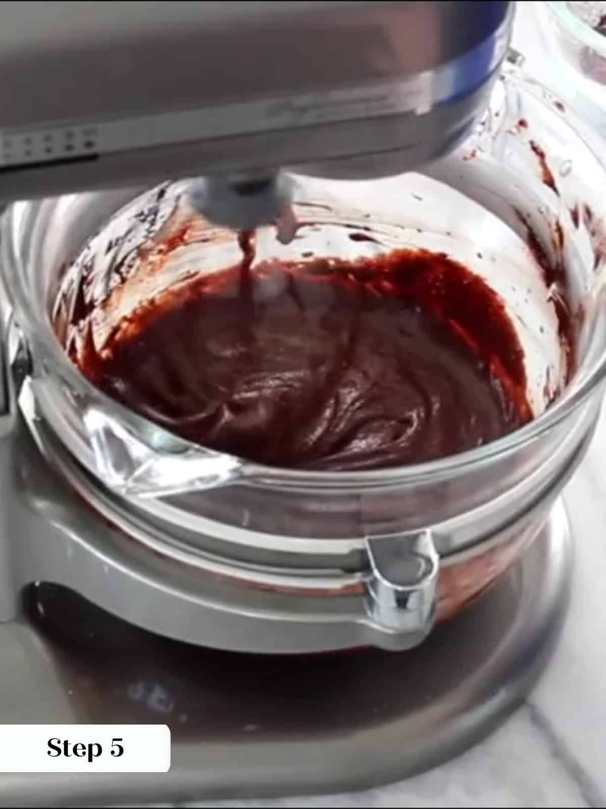 Incorporating melted chocolate into egg foam to create a smooth brownie batter.