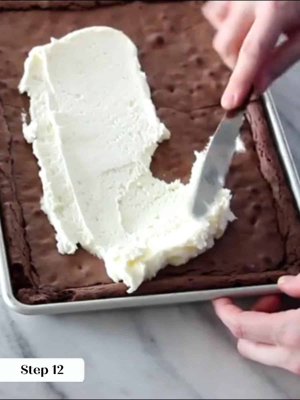 Frosting applied evenly across brownies, creating a festive peppermint topping.