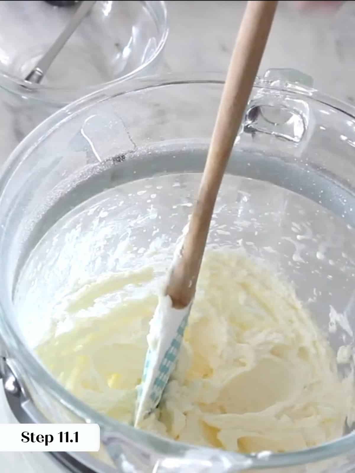Buttercream ingredients partially mixed, thick and heavy before additional whipping creates volume.