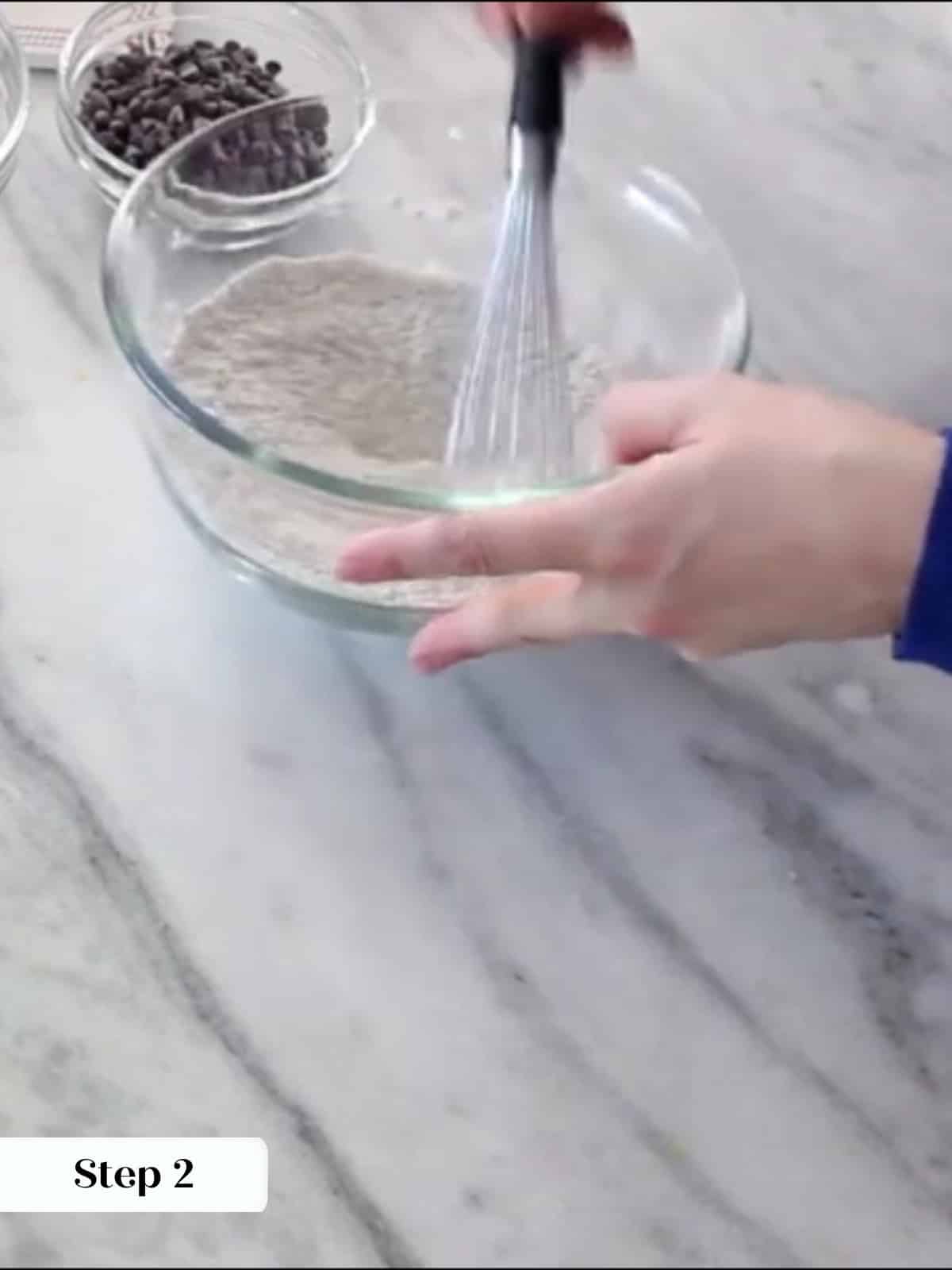 Flour, baking powder, salt, and espresso powder whisked together in a bowl.