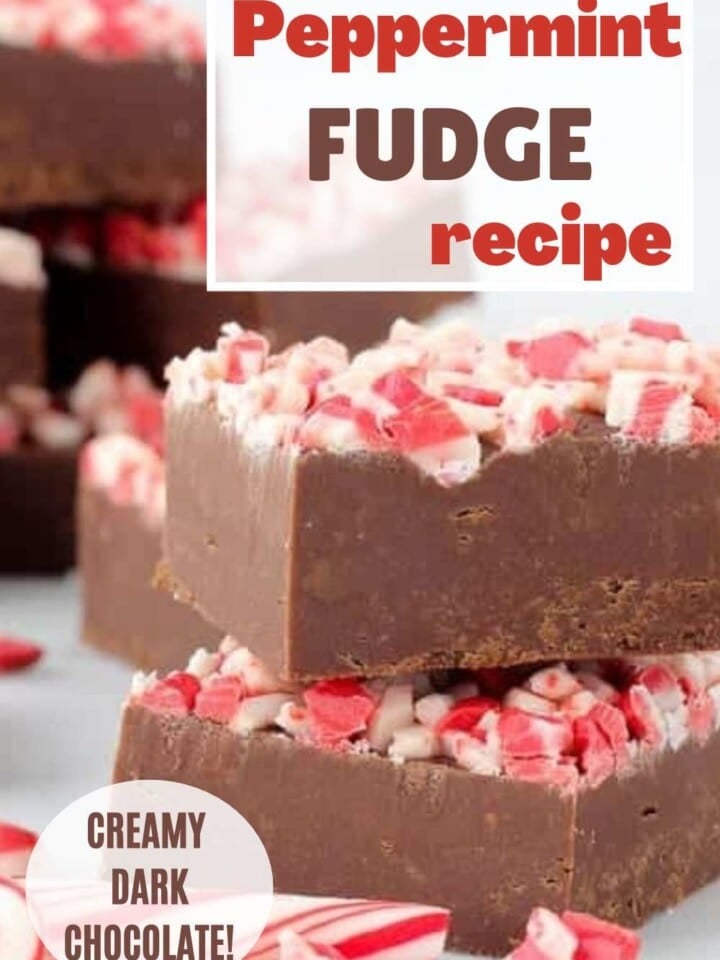 Stack of dark chocolate peppermint fudge squares topped with crushed peppermint pieces.