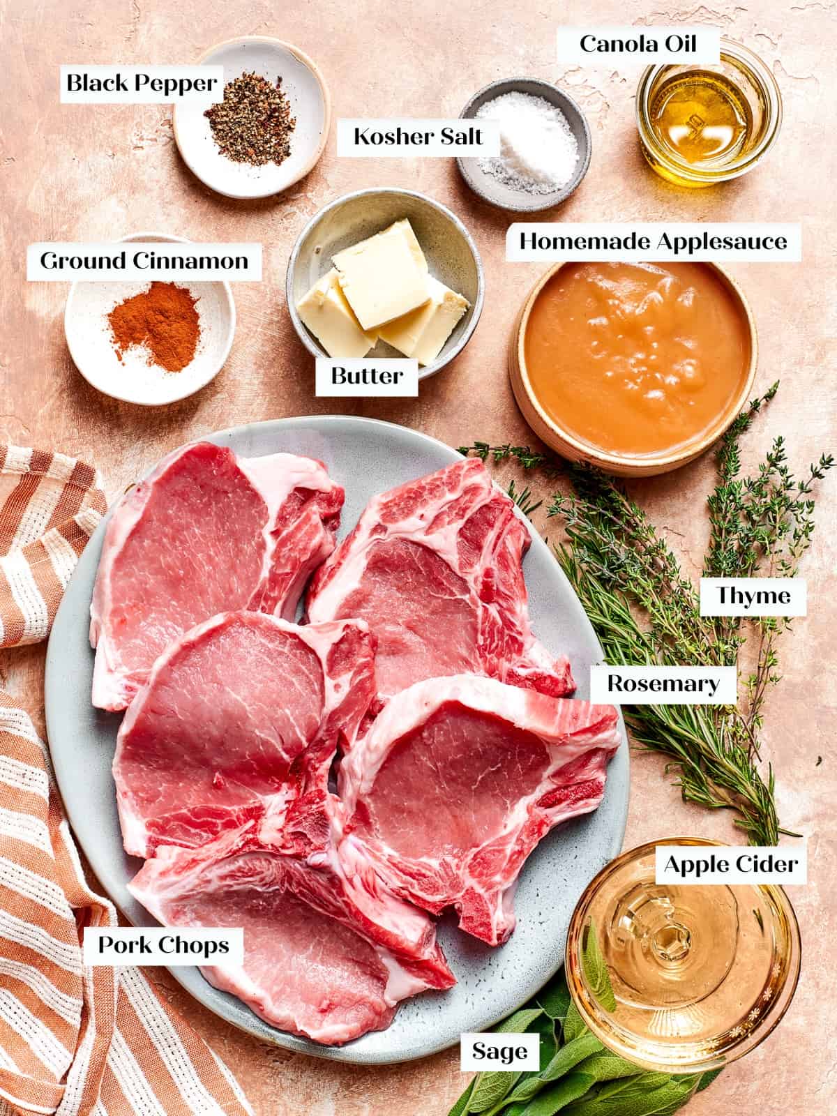 Ingredients for pork chops and applesauce arranged on kitchen counter.