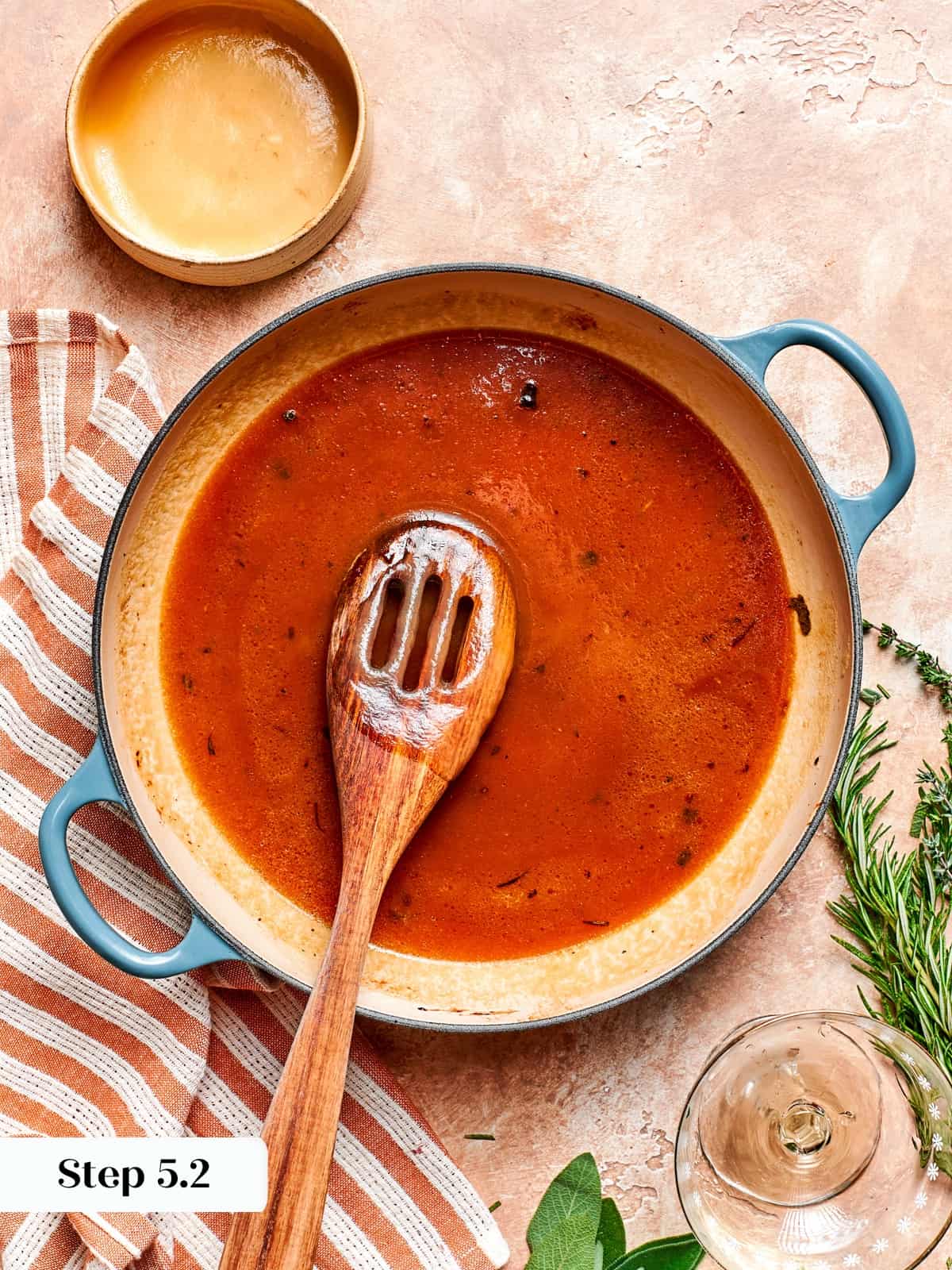 Applesauce sauce stirred in skillet with wooden spoon until smooth.