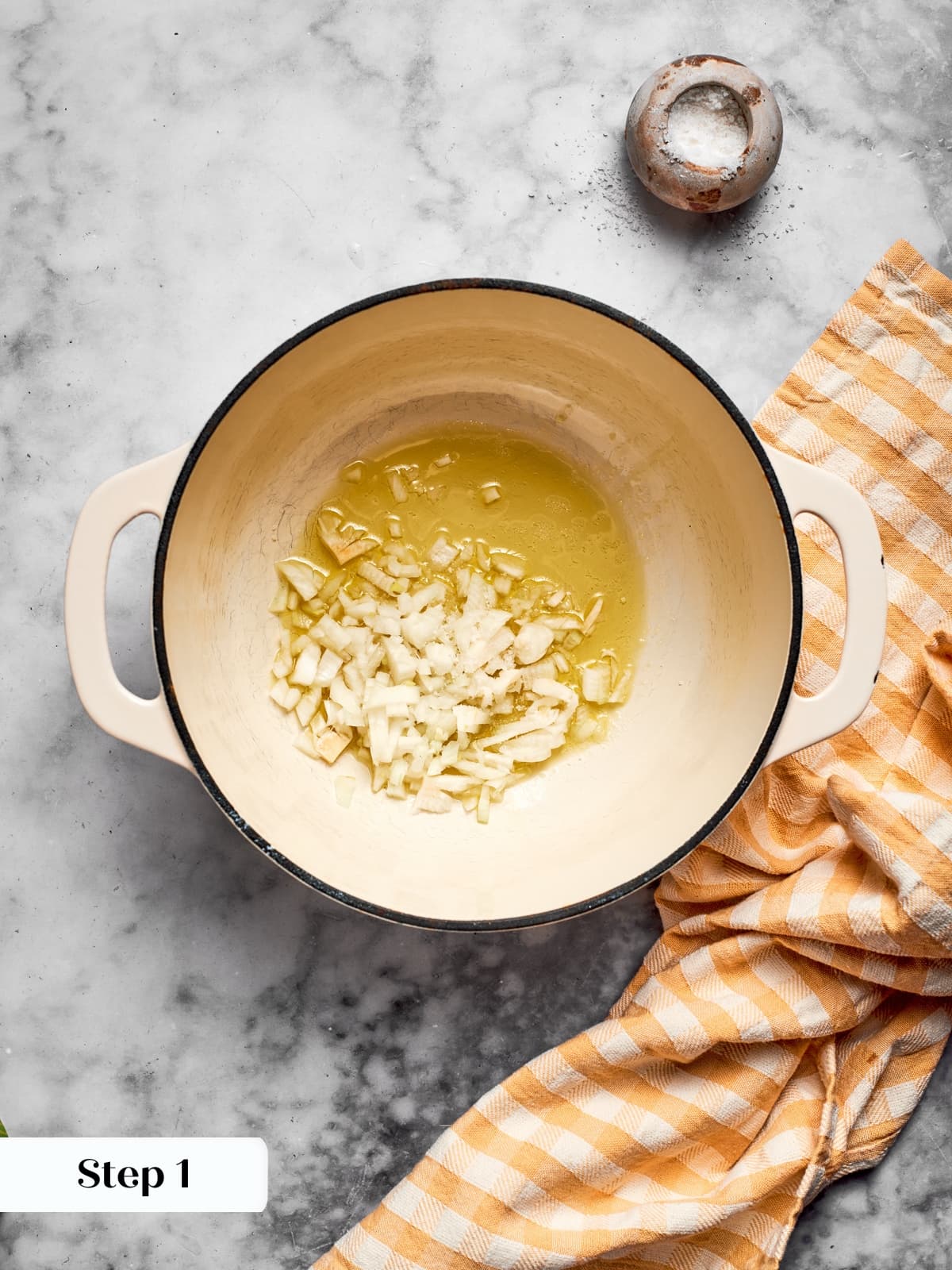 Onions sautéing in a warm pan of olive oil as the recipe begins to come together.