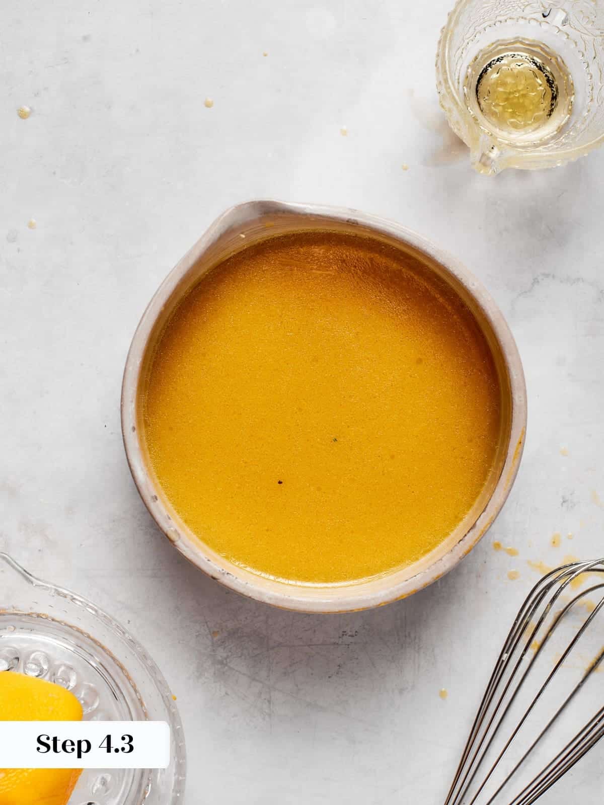 Finished vinaigrette showing creamy texture after whisking ingredients together.