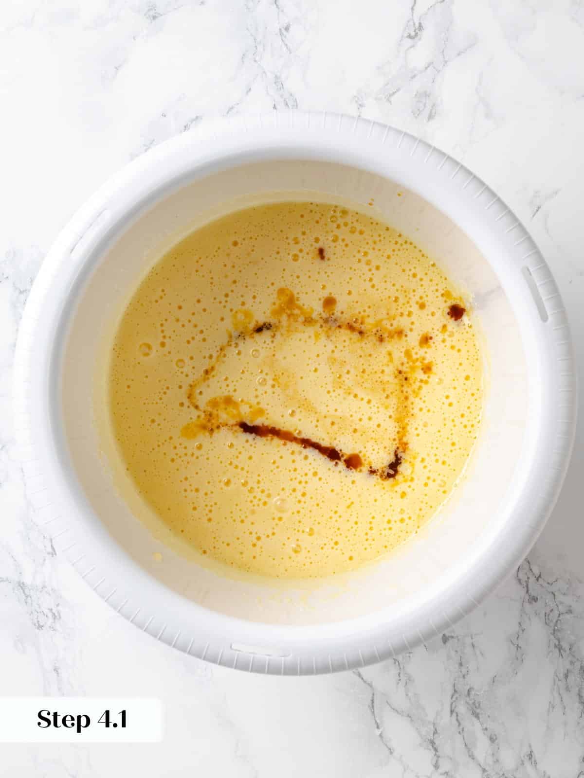 Coffee added to wet ingredients during chocolate cherry cake batter preparation.