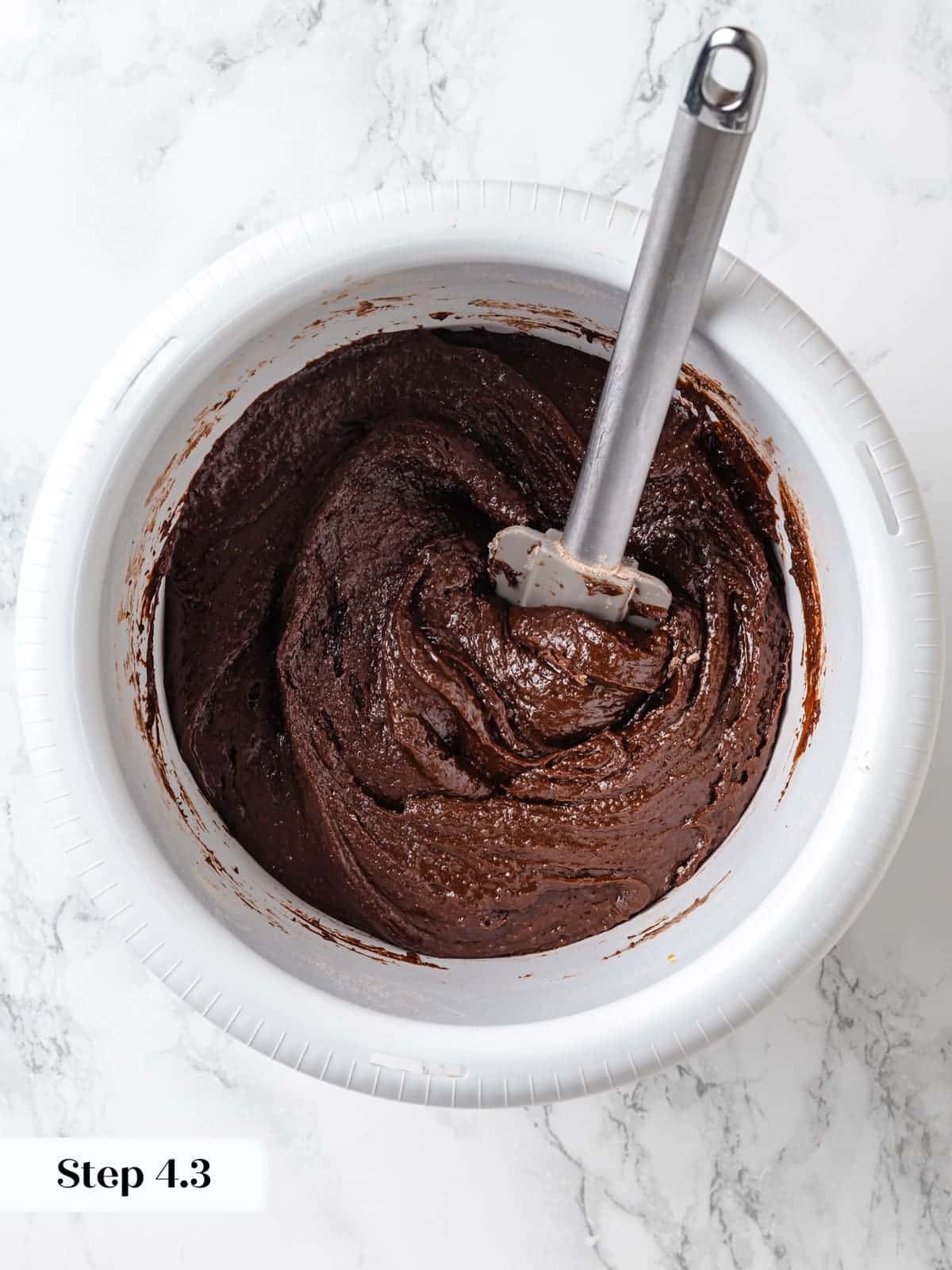 Dry ingredients gently folded into wet chocolate cake batter.
