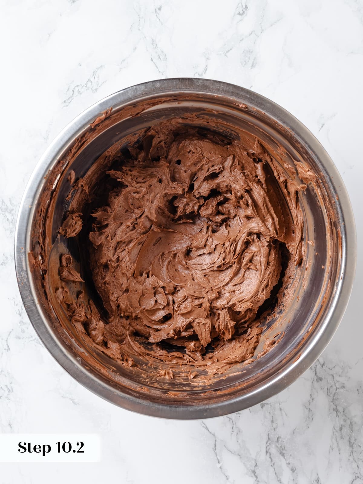 Chocolate cream cheese frosting mixed until smooth and creamy in bowl.