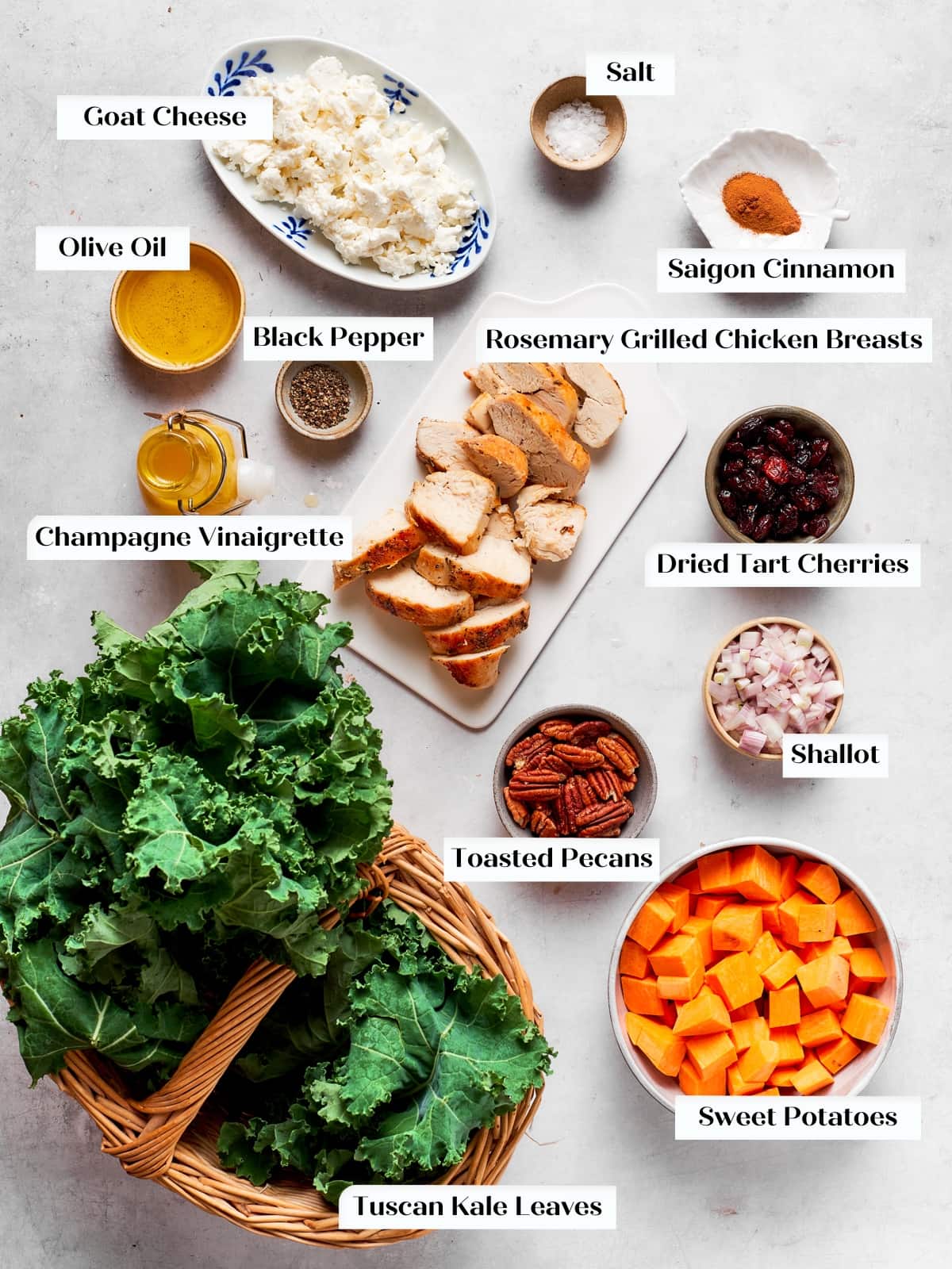 Raw ingredients including kale, sweet potatoes, and toppings prepared for salad.