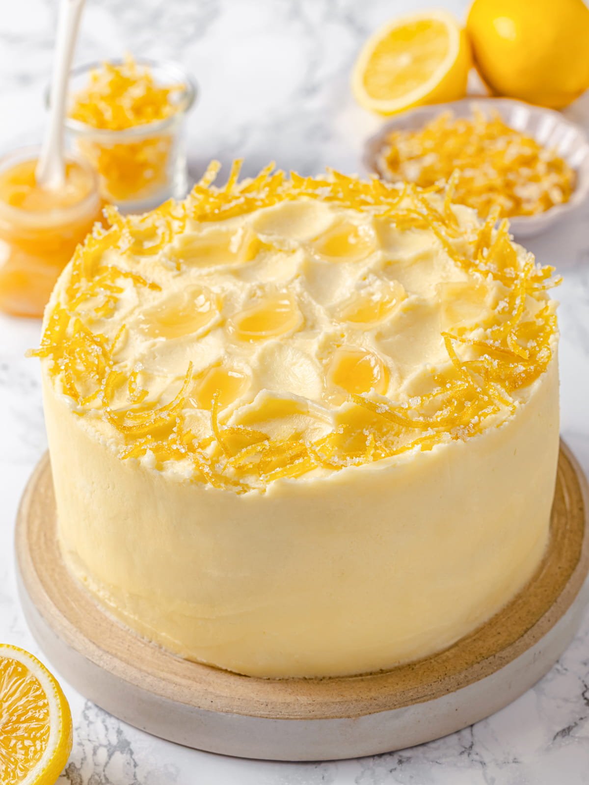 Fully frosted lemon cake finished with smooth lemon Swiss meringue buttercream.